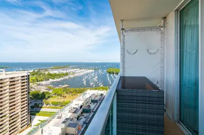 a balcony of a building with a view of a harbor at Cocktails & Coffee with bay & city view balconies in Miami