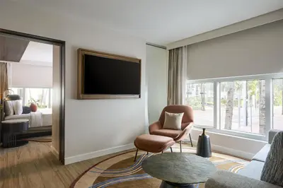 a living room with a tv and a chair at Hyatt Centric South Beach Miami in Miami Beach