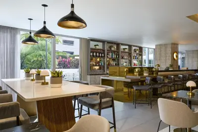 a restaurant with tables and chairs and a bar at Hyatt Centric South Beach Miami in Miami Beach