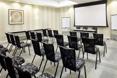 a conference room with chairs and a projection screen at Hyatt Place Miami Airport East in Miami