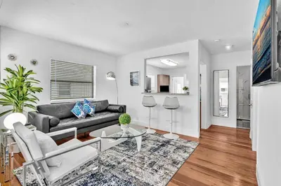a living room with a couch and a table at Dream Hollywood Beach Retreat With Jacuzzi and Fire Pit in Dania Beach