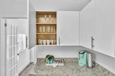 a white kitchen with a sink and a window at Dream Hollywood Beach Retreat With Jacuzzi and Fire Pit in Dania Beach