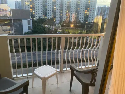 a balcony with two chairs and a view of a city at All you need around you in Sunny Isles Beach
