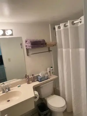 a bathroom with a toilet and a sink and a mirror at All you need around you in Sunny Isles Beach