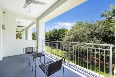 a balcony with chairs and a view of the ocean at Exclusive Doral Villa with Luxury Amenities in Miami
