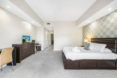 a bedroom with a large bed and a dresser at Exclusive Doral Villa with Luxury Amenities in Miami