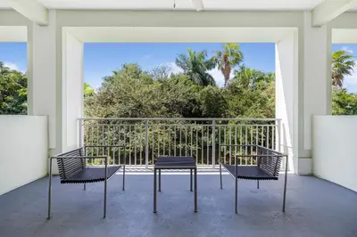a balcony with chairs and a view of trees at Exclusive Doral Villa with Luxury Amenities in Miami