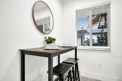 a black table with a mirror and a stool at Koze 2 Bedroom Duplex Home with King & Queen Beds, Near Everything Trendy in Miami