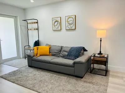 a living room with a couch and a table at Koze 2 Bedroom Duplex Home with King & Queen Beds, Near Everything Trendy in Miami