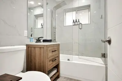 a bathroom with a shower and a toilet and a sink at Koze 2 Bedroom Duplex Home with King & Queen Beds, Near Everything Trendy in Miami