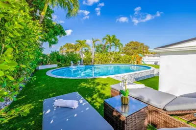 a backyard with a swimming pool and green grass at The Glow House w Cinema, Disco, Pool, BBQ, 9 beds in Ives Estates
