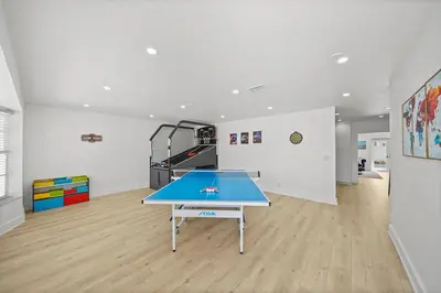 a ping pong table in the middle of a room at Miami Oasis- Pool & Game Fun in Miami