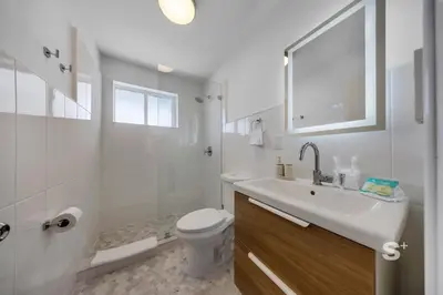 a white bathroom with a toilet and a sink at Stylish 1-BD Apt in Miami Gym, BBQ, Free Parking in Miami