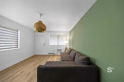 a living room with a couch and a window at Stylish 1-BD Apt in Miami Gym, BBQ, Free Parking in Miami