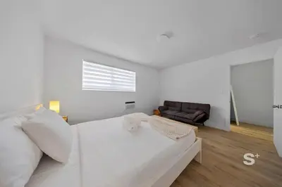 a white bedroom with a bed and a couch at Stylish 1-BD Apt in Miami Gym, BBQ, Free Parking in Miami