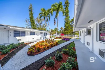 a house with a garden on the side of it at Modern Studio in Miami Gym, BBQ, Free Parking in Miami