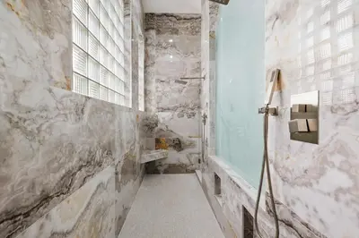 a bathroom with a walk in shower and a window at Spacious home wpool tennis court in Sunrise