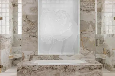 a bathroom with a tub with a statue of a woman at Spacious home wpool tennis court in Sunrise