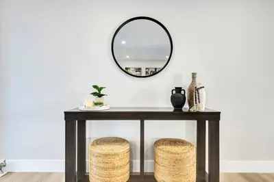 a black console table with a mirror and two stools at Villa Miami Oasis and Heated Pool in University Park