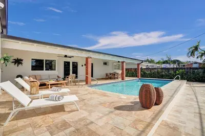 a villa with a swimming pool and a patio at Villa Miami Oasis and Heated Pool in University Park