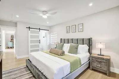a bedroom with a large bed and a ceiling fan at Villa Miami Oasis and Heated Pool in University Park
