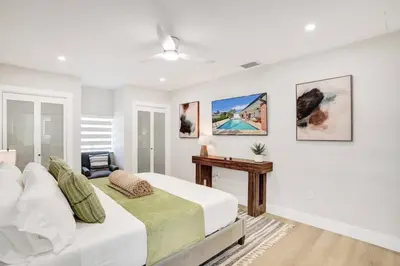 a white bedroom with a bed and a desk at Villa Miami Oasis and Heated Pool in University Park