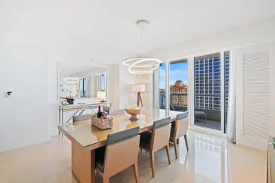 a white dining room with a table and chairs at Ritz-Carlton Luxury Oceanview 3-Bedroom Residence in Fort Lauderdale