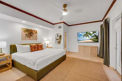a bedroom with a large bed and a window at Grand historic Residence Walk to beach Heated Pool Outdoor kitchen Hibiscus Key Residences in Fort Lauderdale