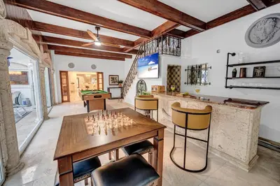 a living room with a chess board on a table at Grand historic Residence Walk to beach Heated Pool Outdoor kitchen Hibiscus Key Residences in Fort Lauderdale