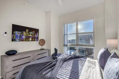 a bedroom with a bed and a large window at Luxury 2BR with City Views on Biscayne Blvd in Miami