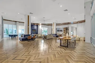 a living room with a table and chairs and a lobby at Luxury 2BR with City Views on Biscayne Blvd in Miami