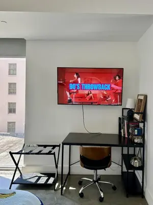 a desk in a room with a tv on the wall at Pop Art Sunlit Apartment Prime Miami Pool Free Parking in Miami