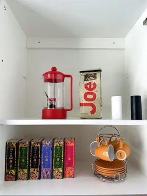 a shelf with books and a blender on it at Pop Art Sunlit Apartment Prime Miami Pool Free Parking in Miami