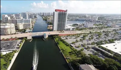 an aerial view of a city with a river and a bridge at Trendy Miami Apartment Walk to the Beach in Hallandale Beach