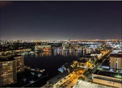 a view of a city at night with the water at Studio Beach Apmt 2 Full Q Beds, Amazing View in Hallandale Beach