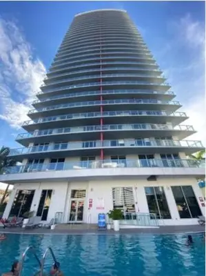 a large building with a swimming pool in front of it at Studio Beach Apmt 2 Full Q Beds, Amazing View in Hallandale Beach