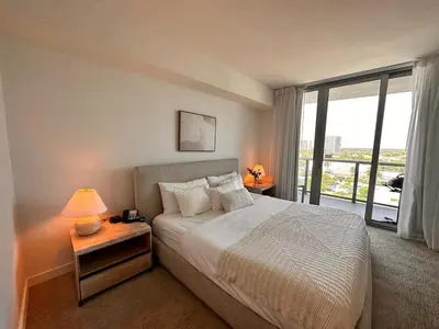 a bedroom with a bed and a large window at 1BR 1BA with Pool & Sun in Miami Beach in Hallandale Beach