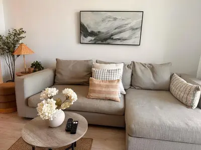 a living room with a couch and a table with flowers at 1BR 1BA with Pool & Sun in Miami Beach in Hallandale Beach