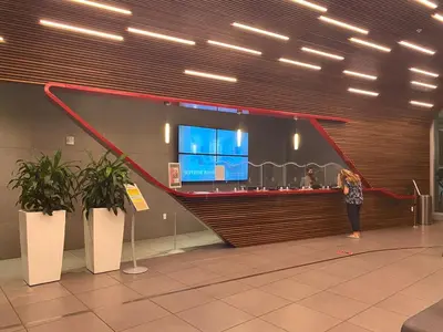 a woman standing at a counter in an airport at Beautiful Studio in Hallandale with Beach & Pool in Hallandale Beach