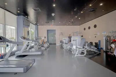 a gym with treadmills and machines in a room at Amazing 2B 2B Luxury Beach Apmt in Hallandale Beach