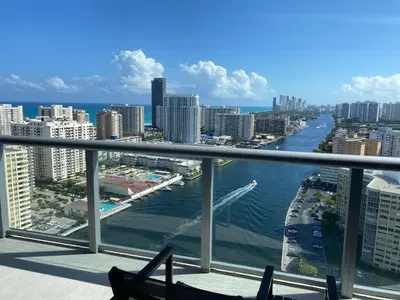 a view of the ocean from a balcony of a city at Dream Beach Apt 1BR, Kitchen & Pool Access in Hallandale Beach