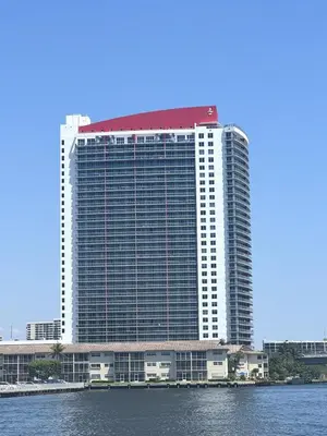 a large building with a red roof on the water at Perfect getaway beach pool and gym 2B 2B in Hallandale Beach