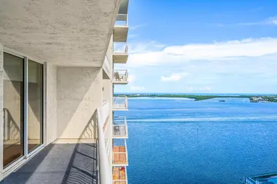 a view of the water from the balcony of a building at Sky High Living with Incredible Views in Miami