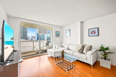 a living room with a white couch and a balcony at Sky High Living with Incredible Views in Miami