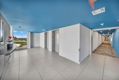 an empty room with a blue ceiling and white walls at Your Miami retreat beach pool and Aventura Mall in Hallandale Beach