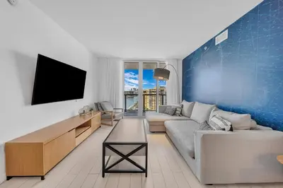 a living room with a couch and a tv at Your Miami retreat beach pool and Aventura Mall in Hallandale Beach