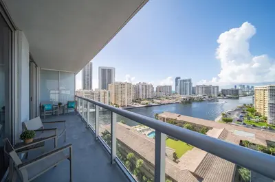 a balcony with benches and a view of a river at Your Miami retreat beach pool and Aventura Mall in Hallandale Beach