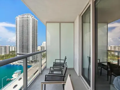 a balcony with chairs and a view of the city at Your Miami retreat beach pool and Aventura Mall in Hallandale Beach