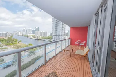a balcony with a view of a river and buildings at Enjoy Miami 2B 2B pool beach and Aventura Mall in Hallandale Beach