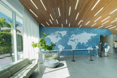 a lobby with a blue wall with a map of the world at Enjoy Miami 2B 2B pool beach and Aventura Mall in Hallandale Beach